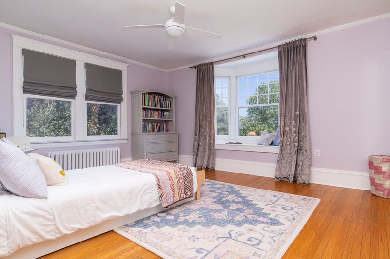 Bedroom with crown molding, light wood-type flooring, radiator, and a ceiling fan
