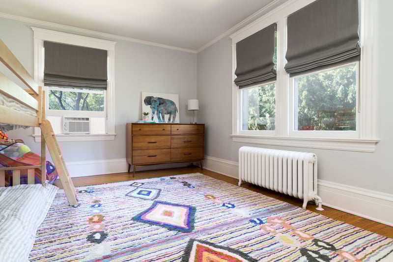 Bedroom featuring radiator heating unit, ornamental molding, and wood finished floors