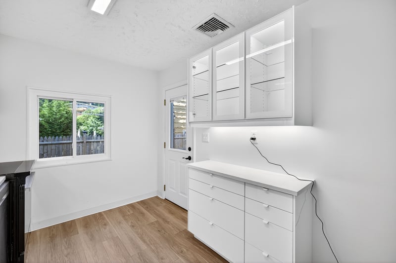 Brand New Kitchen with modern cabinets, Quartz Counters, stainless steel appliances, Door leading to Trex Deck and yard