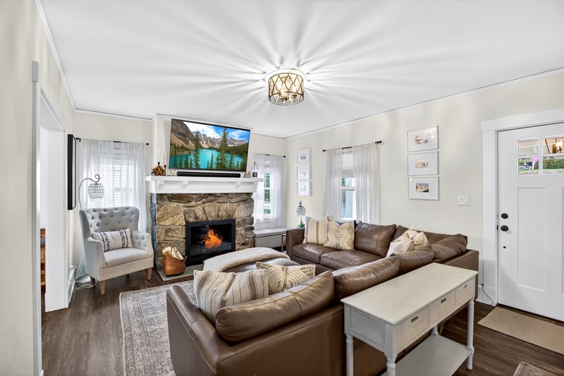 Living rooms with a beautiful stone fireplace.