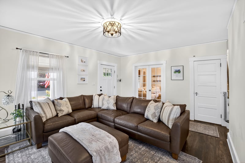 Alternate view of the Living room with french doors that lead to a cozy den with a powder room