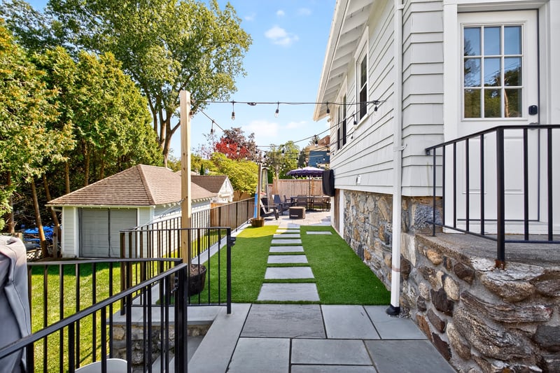 View of yard, patio, and a detached garage.