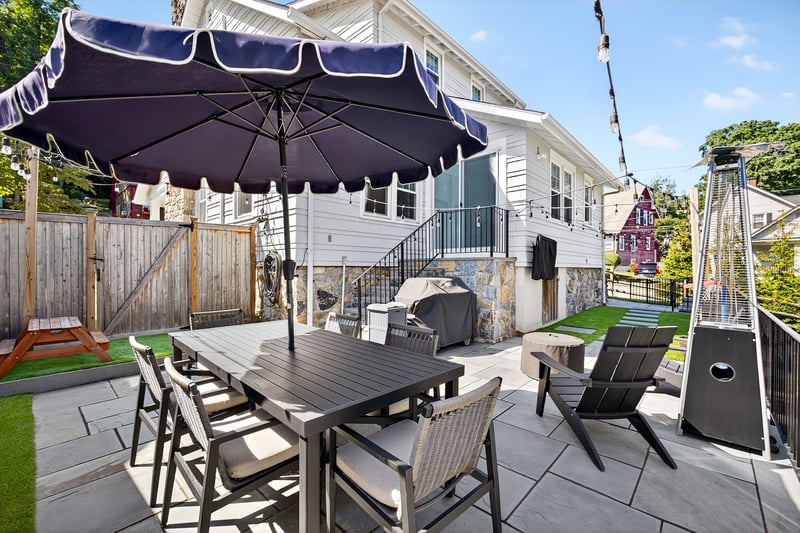 Fenced backyard with a patio, a gate, outdoor dining space, and area for grilling