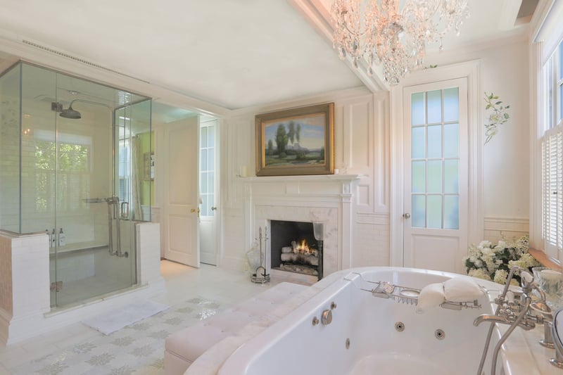 Another view featuring Marble gas fireplace and steam shower.
