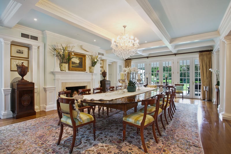 Over-sized Formal dining room with coffered ceiling. Two sets of French doors that lead to the front of the house and the backyard patio,