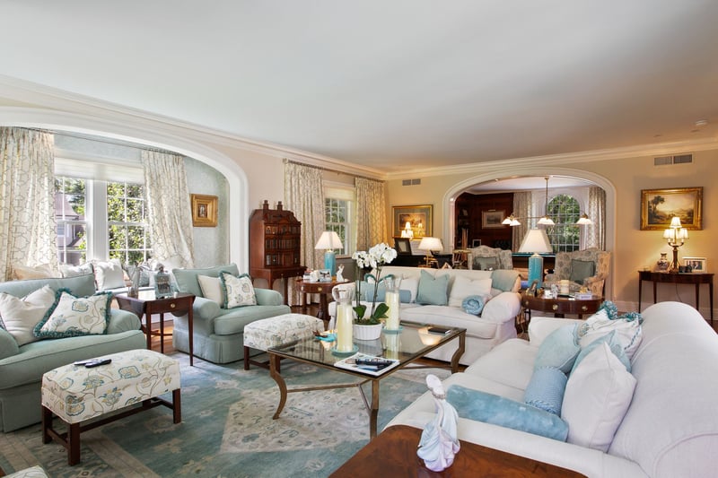 The Formal living room has multiple exposure and a marble wood-burning fireplace. The perfect place to get cozy with family and friends.