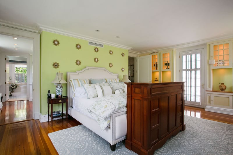 Another view of the Primary Suite showing the dressing area with his and hers walk-in closets with custom built-ins!