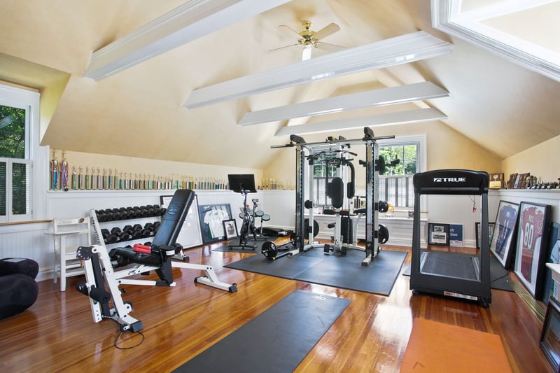 This second floor bedroom is currently being used as an-in home gym! Compete with wood beams and built-in wall mirrors