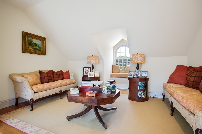 Living area with vaulted ceiling and wood finished floors