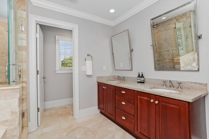 Double vanity in primary bathroom with private water closet