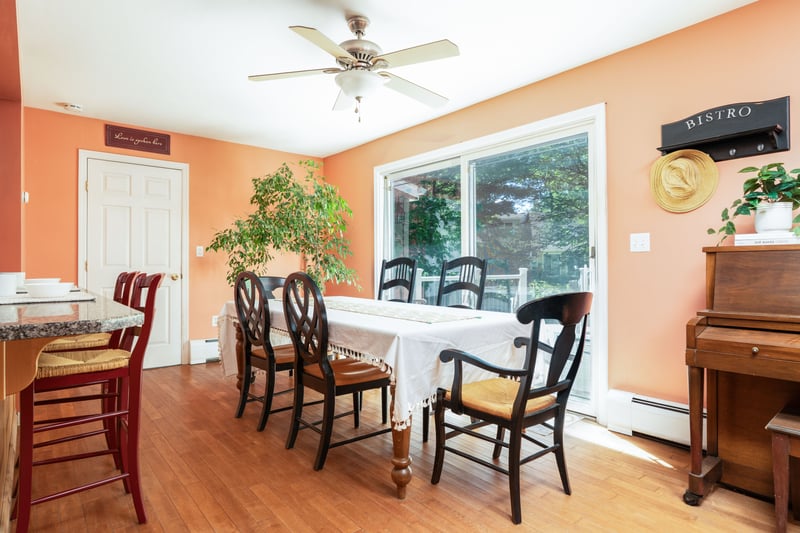 Dining space featuring wood flooring and a ceiling fan