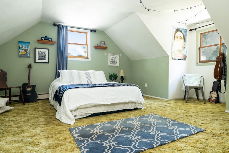 Upstairs bedroom featuring vaulted ceiling.