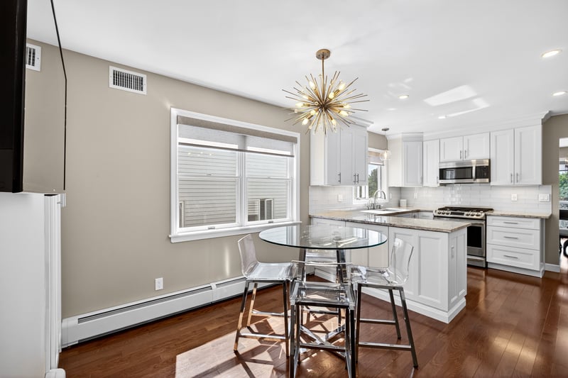 Beautiful Kitchen featuring quartzite countertops, stainless steel appliances, ample white cabinetry, decorative backsplash, and recessed lighting.