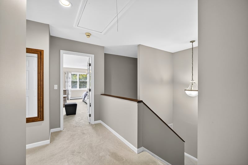Corridor with an upstairs landing, light carpet, attic access, and recessed lighting