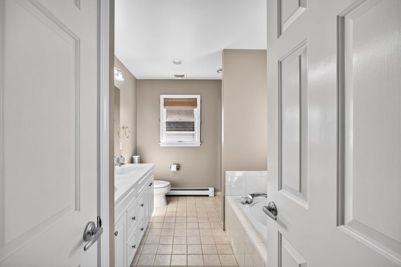Primary bathrooms offers a jetted tub, double vanity, shower and linen closet.