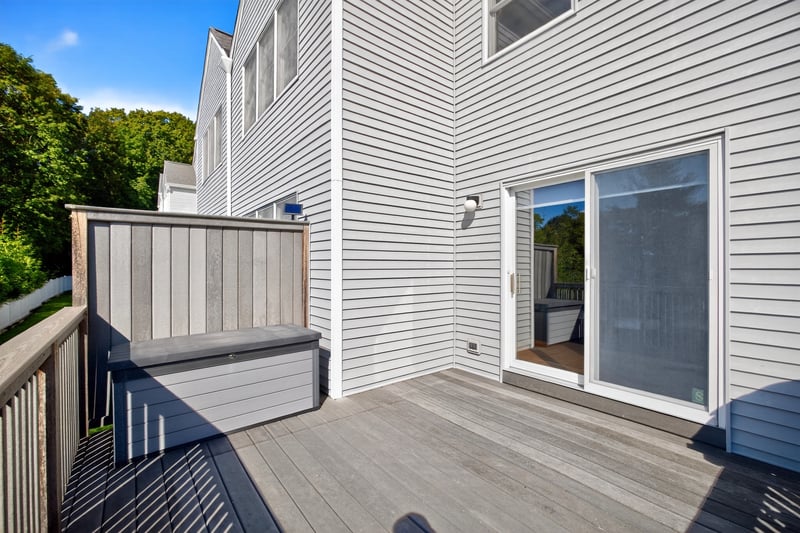 View of deck with sliders that lead to the main open-concept living area on the main floor.