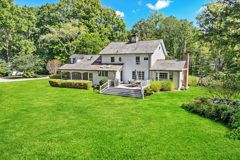 Sited on over 2 beautiful acres of pricavy with mature trees and perennial beds galore!