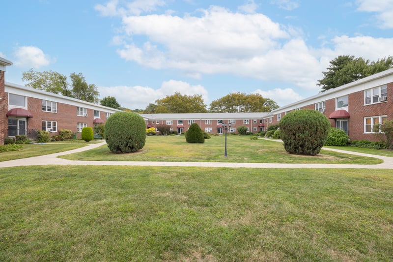 View of home's community with a lawn