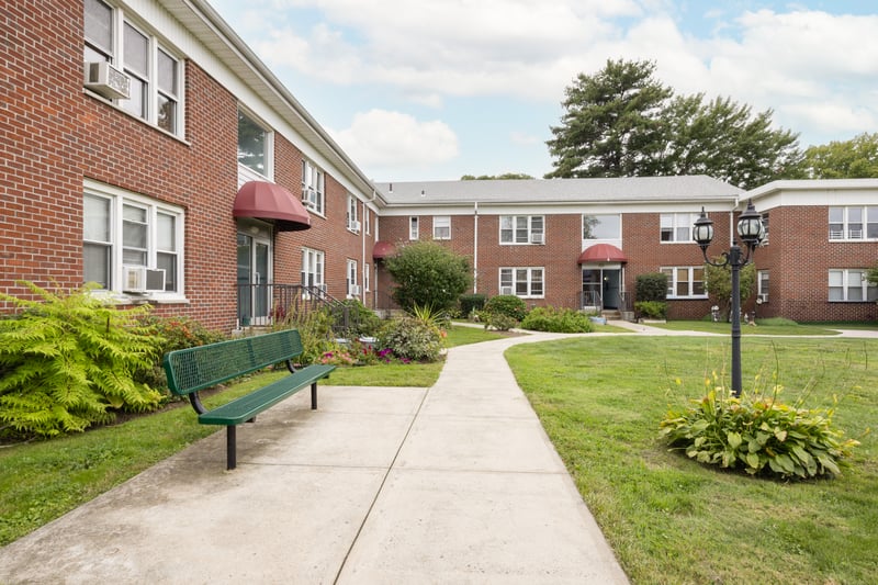View of property's community with a lawn