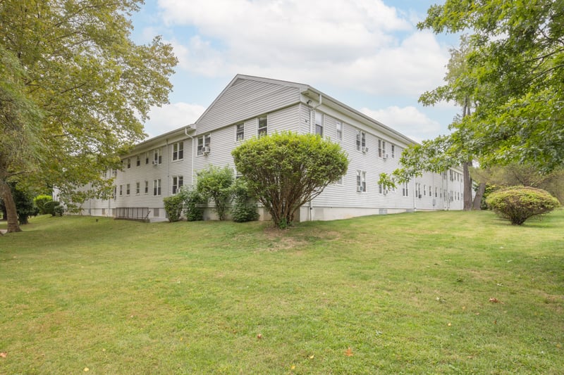 View of side of home featuring a lawn