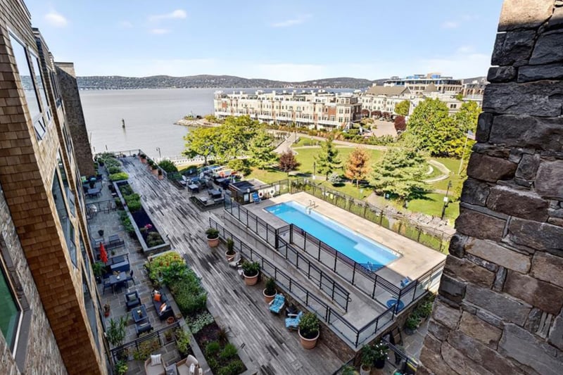 view of river, deck and pool area from balcony