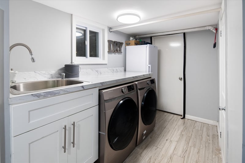 Laundry room with bathroom across the way.