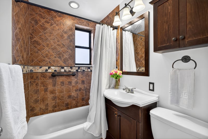 Full bathroom with shower / tub combo with curtain and vanity