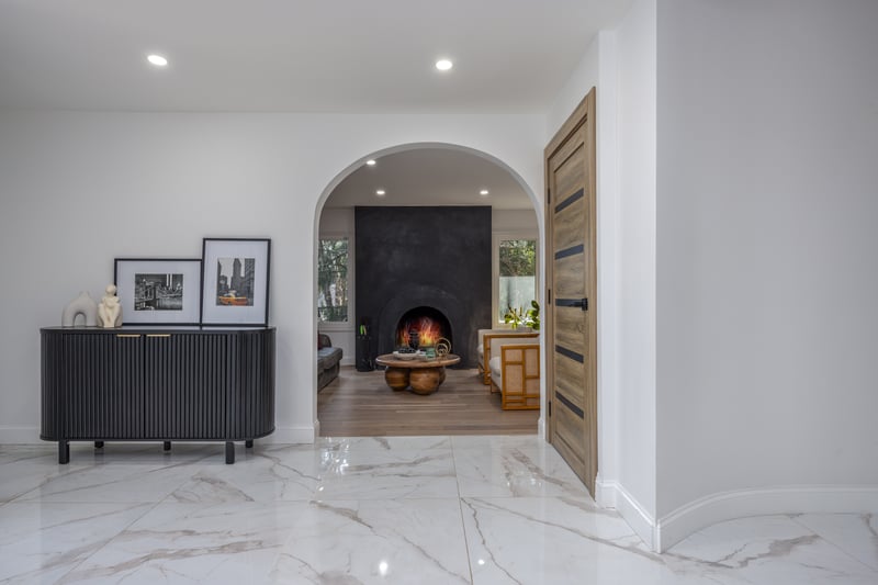 Hallway featuring marble tiled floors and recessed lighting...