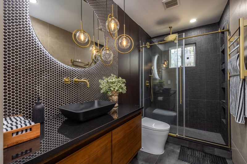 Bathroom featuring a stall shower, vanity, dark tile patterned flooring, and recessed lighting