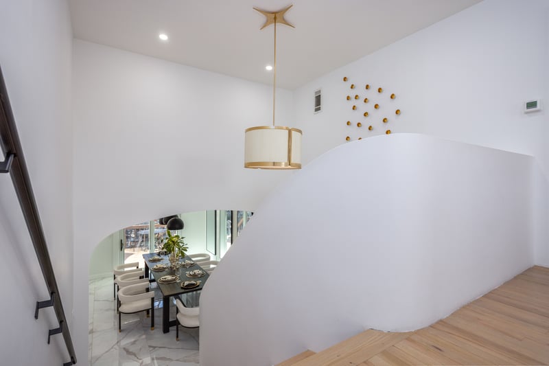 Stairs with marble finish flooring, recessed lighting, and arched walkways...