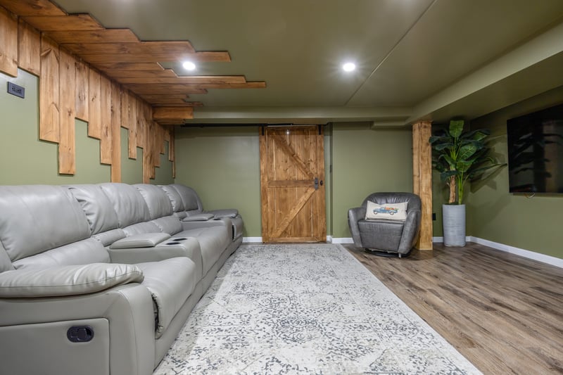 Living room with a barn door and wood finished floors...