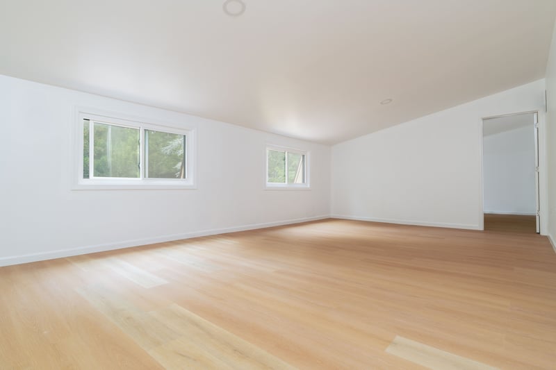Unfurnished room featuring lofted ceiling and light wood finished floors