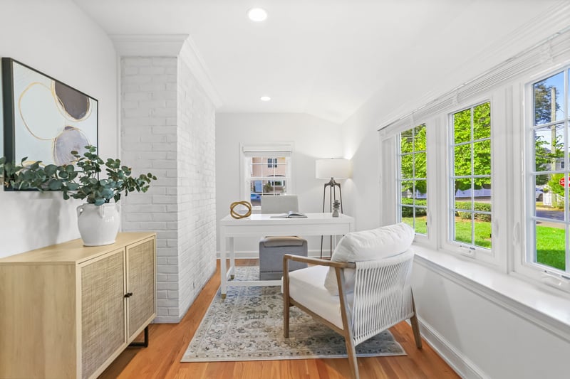 Cozy office tucked off kitchen area. Could be a great playroom!
