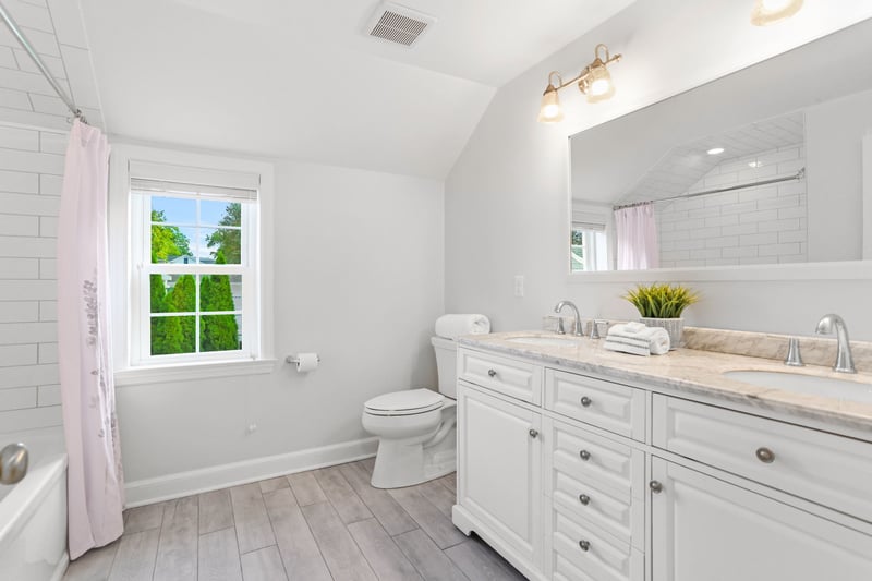 Large hall bath upstairs with double sinks.