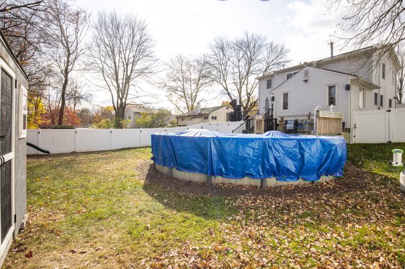 Fenced backyard featuring a gate