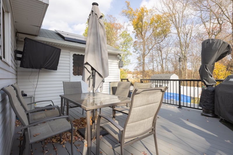 Wooden terrace with outdoor dining area and area for grilling
