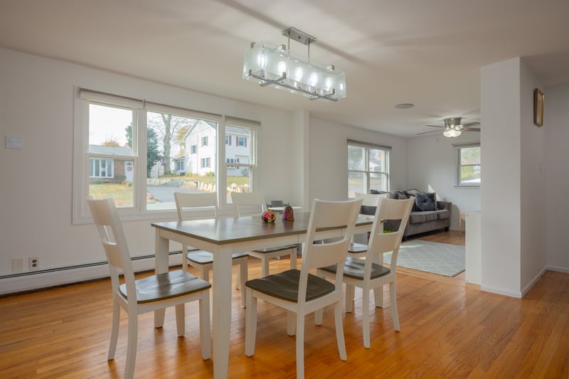 Dining space featuring light wood-type flooring, baseboard heating, and a ceiling fan