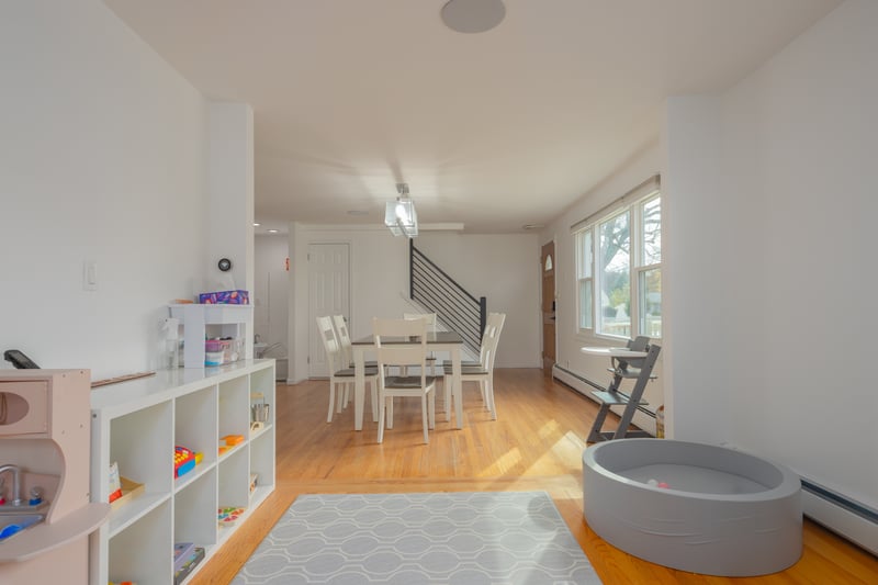 Dining room featuring light wood-style flooring, a baseboard heating unit, stairway, and baseboard heating