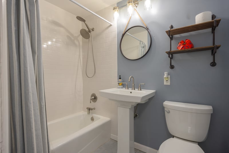 Full bathroom with shower / tub combo with curtain and tile patterned flooring