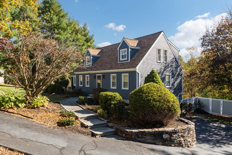 Driveway that leads to under house, 2 car garage and storage shed.