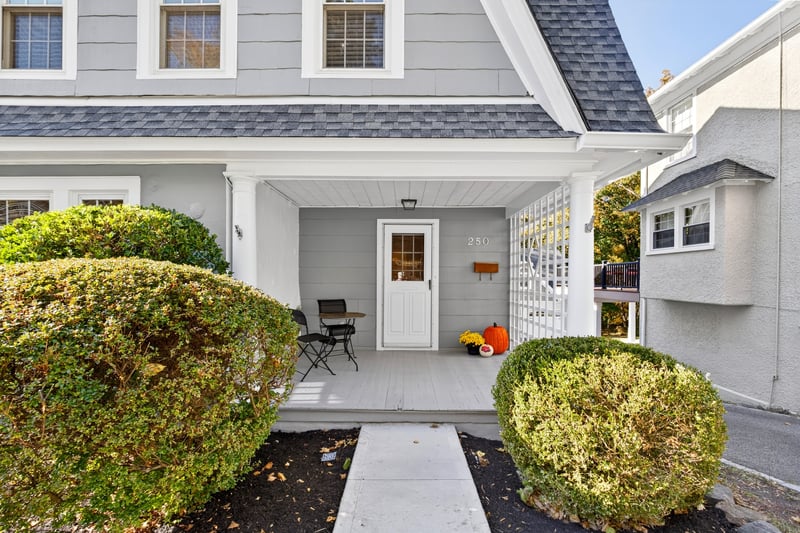 Welcoming covered front porch with wood lattice detail