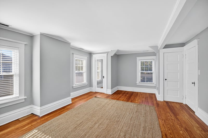 Main bedroom with double closet and beautifully refinished hardwood floor