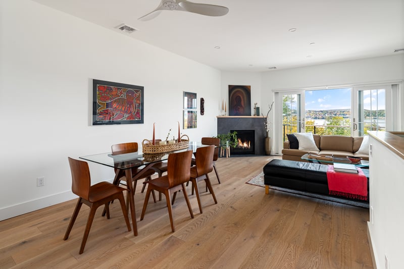 Dining area open to living room and gas fireplace and views.