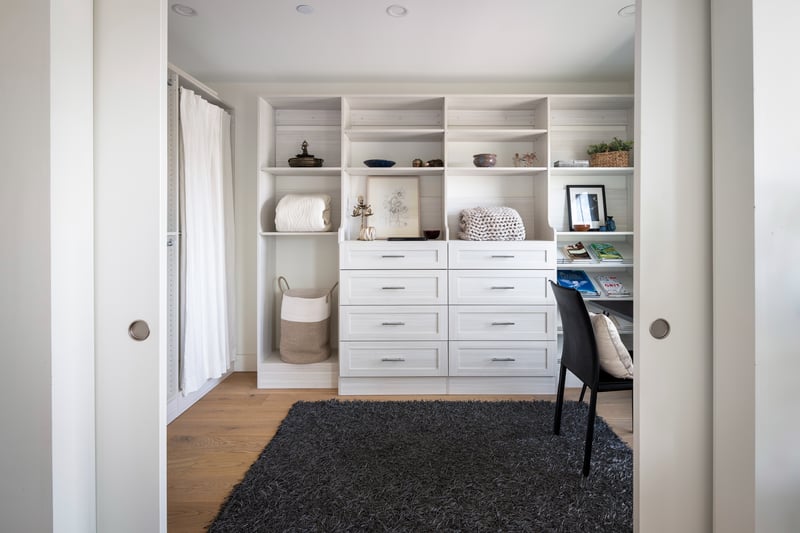 Flex room, office/dressing room with custom built-ins and sliding doors for privacy.