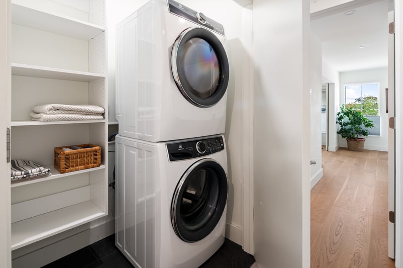 Great hall laundry closet on the 2nd floor bedroom level with built-in storage shelves.
