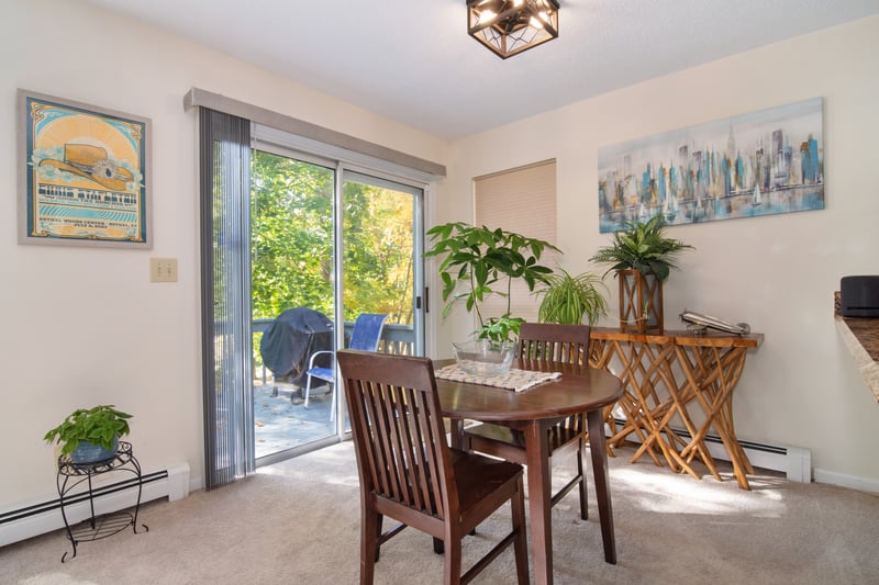 A formal dining area is complemented by sliding glass doors to a private deck — an ideal setting for summer barbecues and relaxed outdoor gatherings.