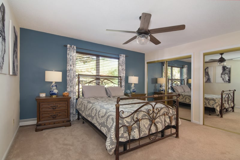 A large primary suite with a striking accent wall boasts abundant closet space for all your storage needs.