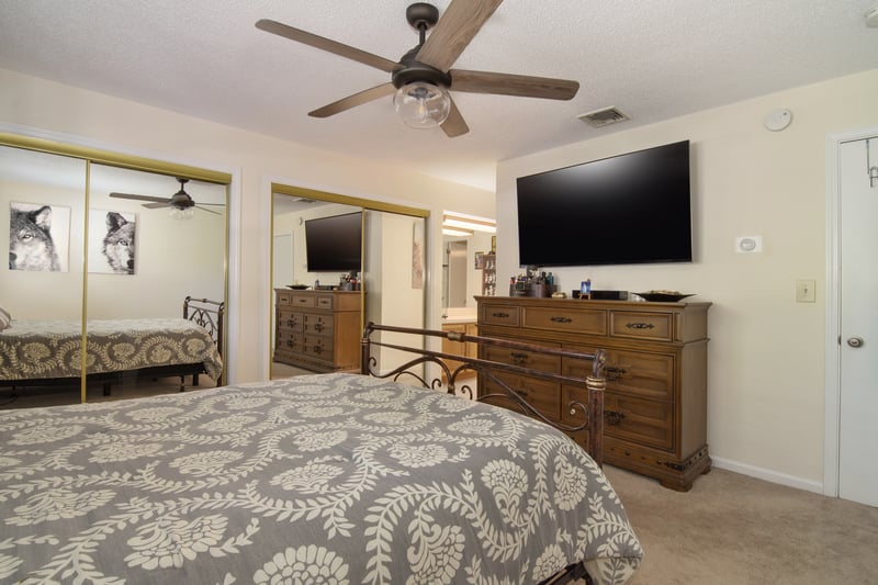 This bedroom offers a natural transition to a dedicated dressing space and full bathroom.
