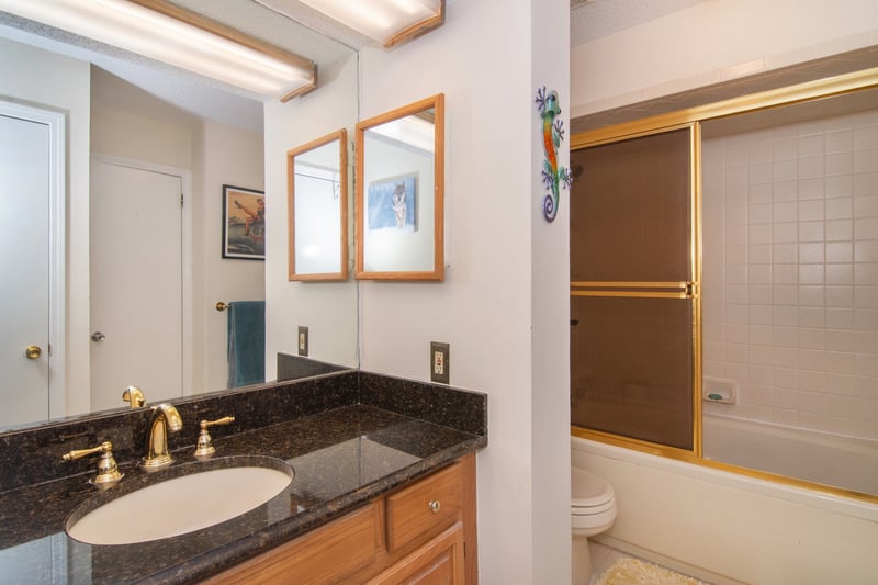 Relax in the privacy of an en-suite bath featuring a granite-topped vanity and a tub/shower combo.