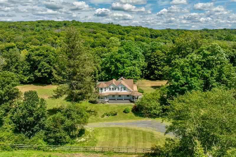 View of subject property with a forest